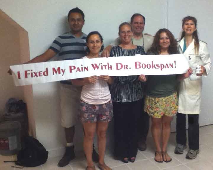 ALT =[“Dr. Jolie Bookspan: Dr. Bookspan with students of classes to fix their pain.”] 