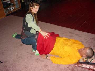 ALT =[“Dr. Jolie Bookspan: Showing Thai massage techniques to Senior Monk Lama Tenzing of the Tibetan Medical School”] 